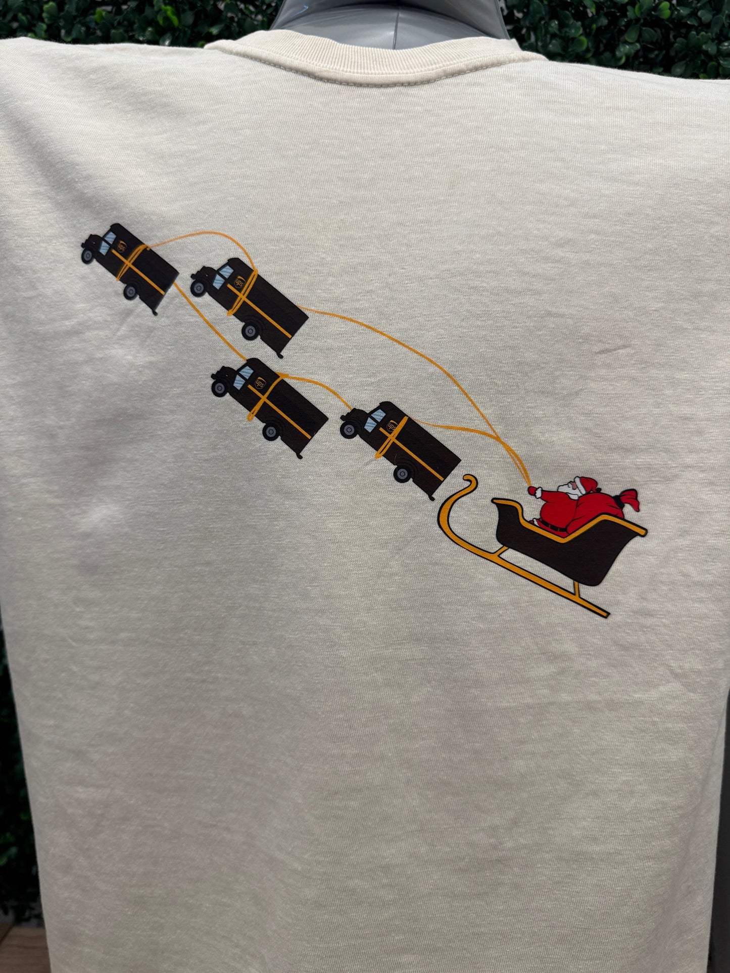 UPS Santa Peak Season Christmas Tee with Santa in a sleigh, pulled by UPS trucks.