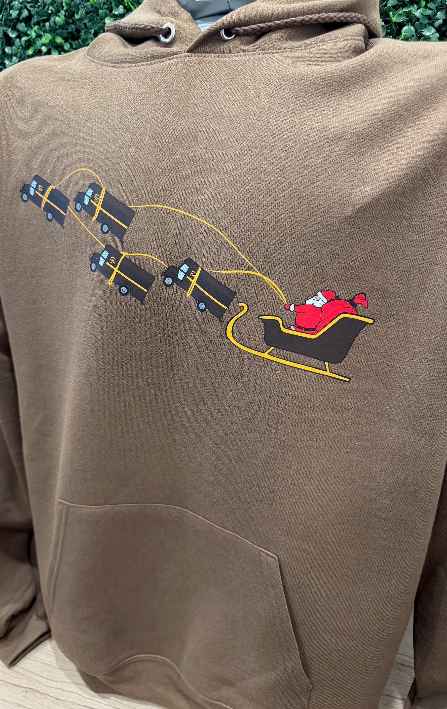 UPS Santa Peak Season Christmas Hoodie with Santa design and UPS trucks.