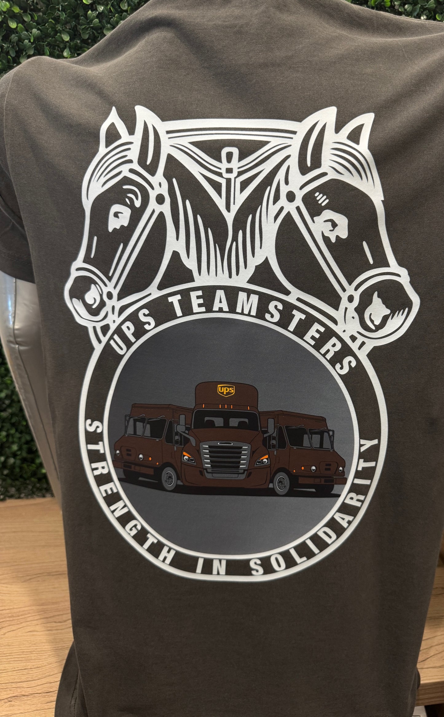 Gray t-shirt with a graphic of two horses and a truck, featuring 'UPS Teamsters Strength in Solidarity' text.